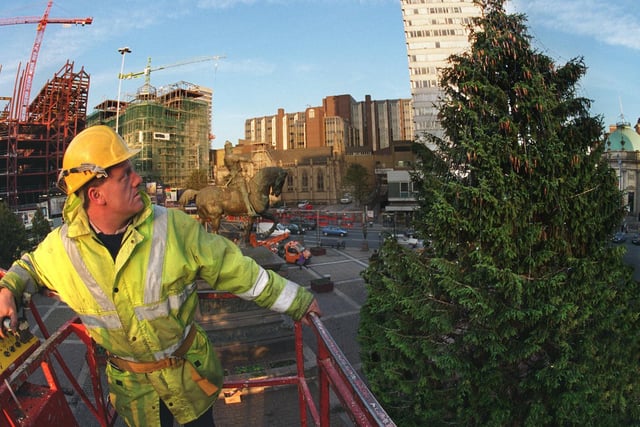 Leeds City Council electrician Mick Leak weighs up the task of fitting more than 2,500 lights to the 55ft Christmas tree in City Square.