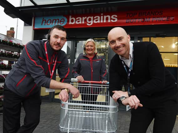 Happy to help - Staff members, from left, store manager Jordan Gillman, Amanda Firth and area manager Daniel Wilding outside the store