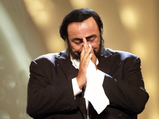 Luciano Pavarotti performing in a home town gig in an amphitheatre in Modena, Italy, which Dave describes as one of the best ever gigs he has covered.