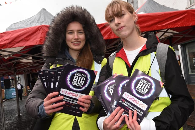 from left, Olivia and Eleanor Pape hand out programmes to the public.