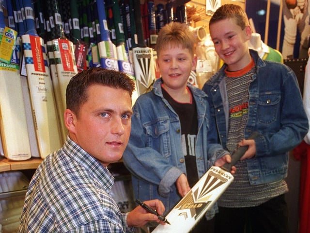 England and Yorkshire cricket star, Darren Gough, signs autographs for fans in October 1996. He is pictured with young Garforth Cricket Club players, Daniel Mann, left, and James Fender.