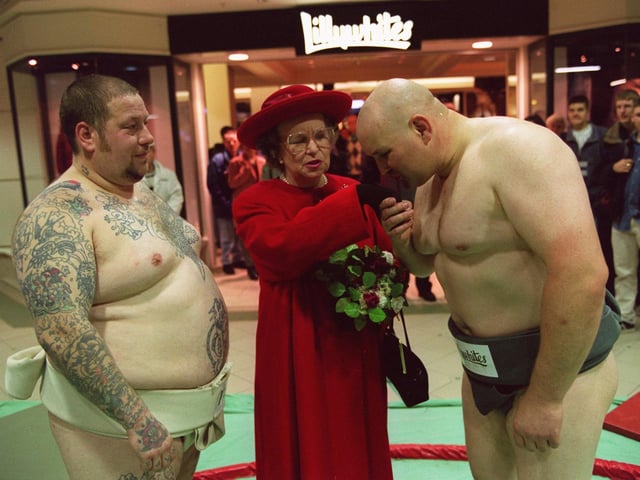 Sumo Wrestlers, George Chambers weighting 23stone, left, and Steve Patterns a mere 19 stone get met Queen impersonator Elizebeth Richards at the store opening in October 1996.