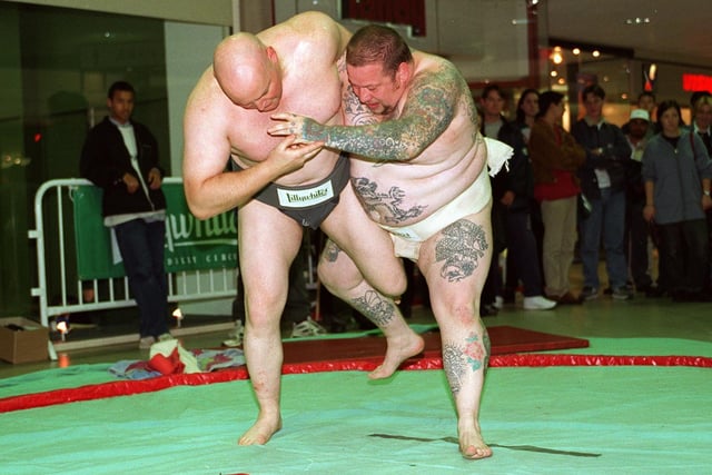 Sumo wrestlers, Steve Pattern (left) and George Chambers battle it out in front visitors to the new store in October 1996.