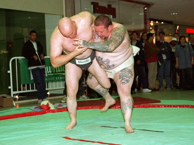 Sumo wrestlers, Steve Pattern (left) and George Chambers battle it out in front visitors to the new store in October 1996.