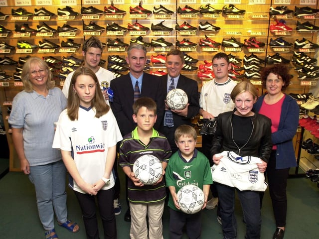 Lillywhites manager Bruce Milton presents competition winners with their prizes in July 2000.