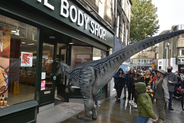 Richie Raptor nips into the Body Shop during the Dino Day in Lancaster City Centre. Photo: David Hurst