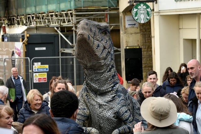 Richie Raptor goes shopping during the Dino Day in Lancaster City Centre. Photo: David Hurst