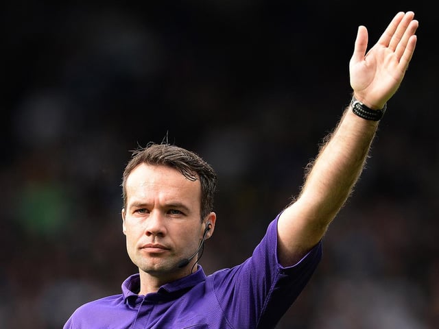 Oooh, its a corner! Referee Paul Tierney signals the way during the game.