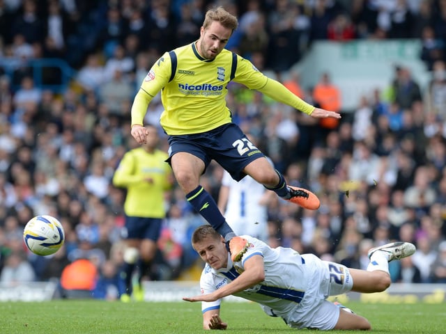 Birmingham, City's Andrew Shinnie skips over the challenge of Scott Wooton.