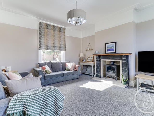 The large living room is ideal for sitting back and relaxing with family. It has a double glazed bay window to the front, double glazed window to the rear and a stunning feature fireplace with electric living flame fire.