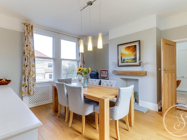Across the hall is the formal dining room. The bright and airy space offers plenty of room for a large dining table, ideal for special mealtimes together.