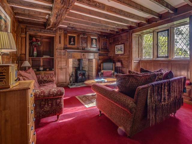 Beams and oak panelling, with mullion windows, transport you back in time within this reception room.