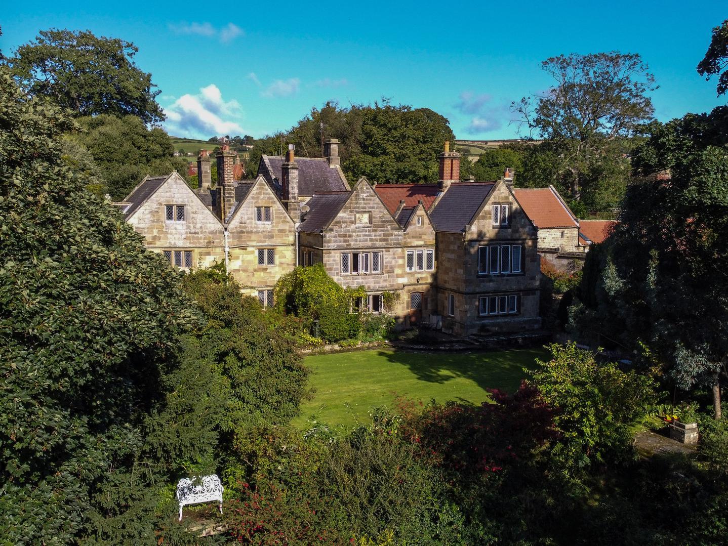 Extensive landscaped gardens have lawns, pathways, an orchard, a pond, and even the odd statue.