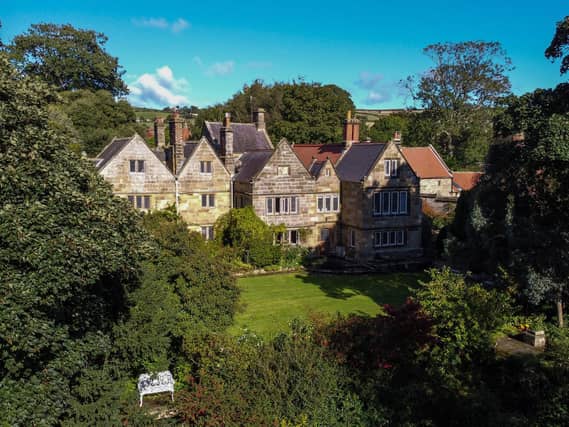 Extensive landscaped gardens have lawns, pathways, an orchard, a pond, and even the odd statue.