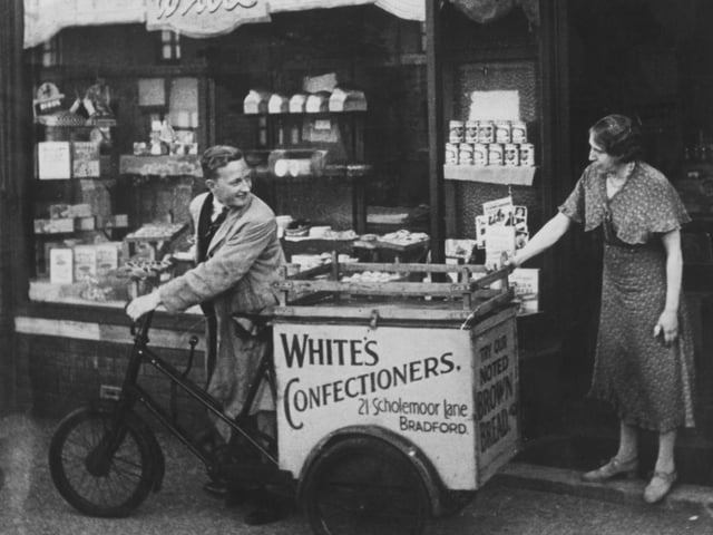 A deliveryman leaves White's confectioners shop on Scholemoor Lane, Bradford, in 1938.