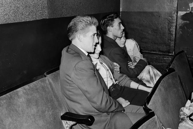 Couples at the Western Talkie Theatre in Bradford make the most of 'couple's chairs', designed without a central arm rest.