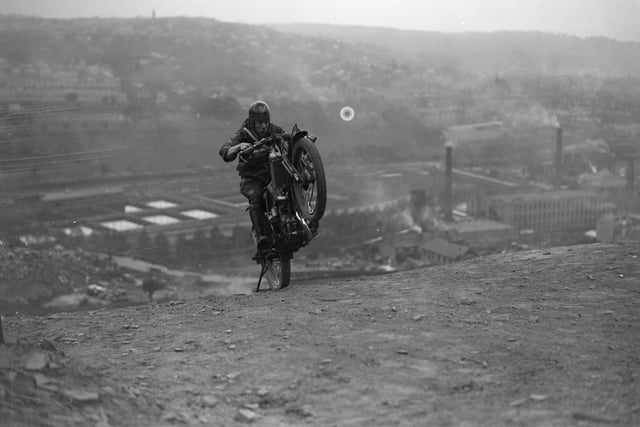 Doing a 'wheely' on a on a motorbike whilst hill climbing near Bradford in May 1927.