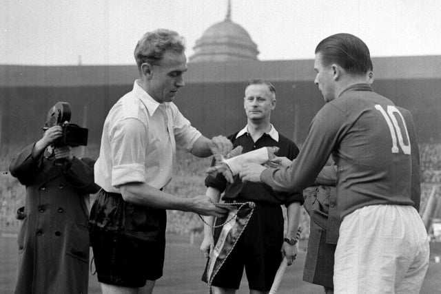 Billy Wright, pictured with Hungry skipper Pukus, was the first footballer to earn 100 international caps. He played 105 times for England.