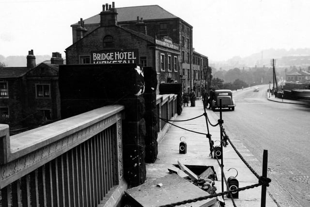 May 1946 and a view looking along north side of Bridge Road over Kirkstall Bridge showing damage to pavement. The Bridge Hotel can be seen on the left.