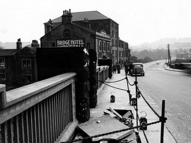 May 1946 and a view looking along north side of Bridge Road over Kirkstall Bridge showing damage to pavement. The Bridge Hotel can be seen on the left.