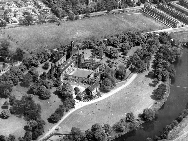 The grounds of Kirkstall Abbey in May 1949. The cruciform church is towards the left with the open air cloister in the centre. Footpaths were added to the site during a programme of conservation and restoration between 1892 and 1896