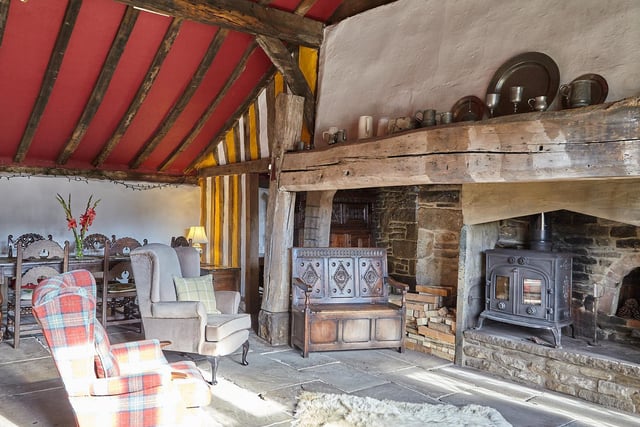Beams and a huge wood and stone fireplace dominate this characterful chamber.