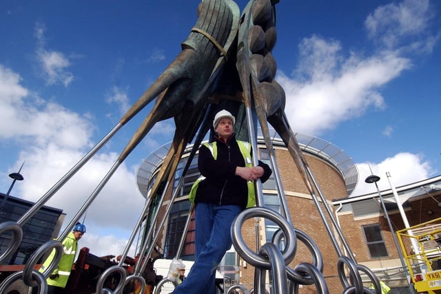 Ian Randall with his sculpture entitled Steeped Vessels is fixed into position at Brewery Wharf in February 2006.