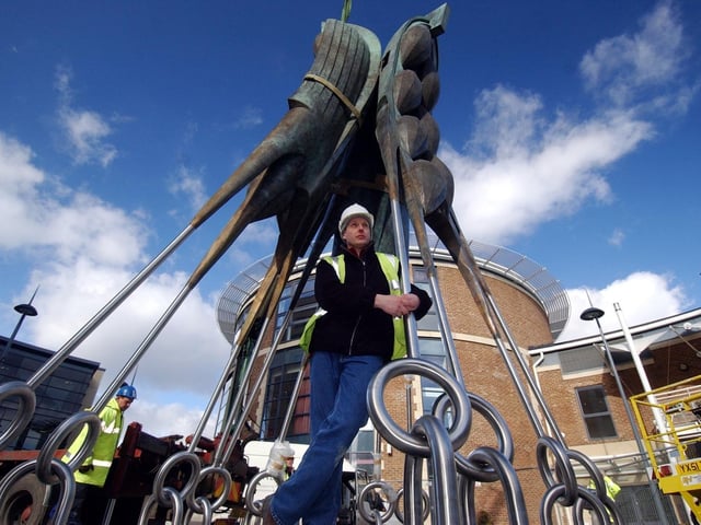 Ian Randall with his sculpture entitled Steeped Vessels is fixed into position at Brewery Wharf in February 2006.
