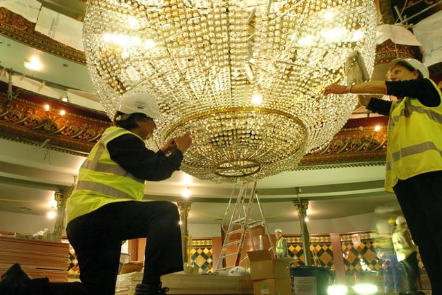 Michael Wilks (left) and Sheila Coates help clean the huge chandelier at the Leeds Grand as part of the theatre's refurbishment in June 2006.