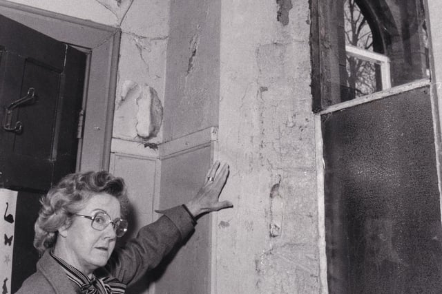Christ Church Upper Armley C of E Primary on Theaker Lane was suffering from classroom walls running with rainwater, and plaster crumbling from the ceilings.  Headteacher Doreen Smith points out issues in June 1979.