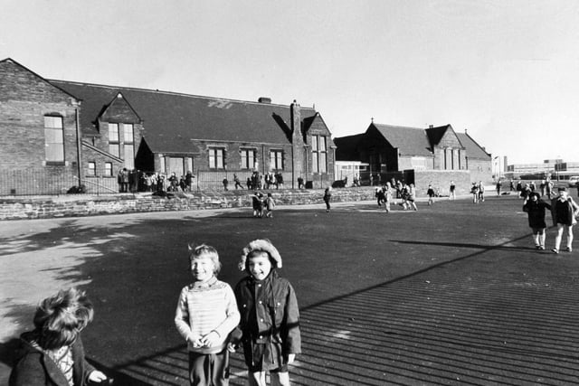 Children on the playground at St. Hilda's C of E Primary School on Cross Green Lane in February 1974.
