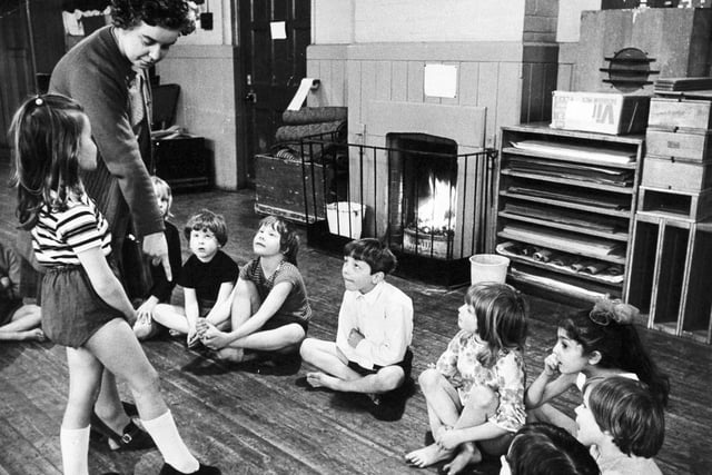 A teacher gives instruction in one of the classrooms heated by an open fire at Armley Church of England Primary on Wesley Road in January 1974.
