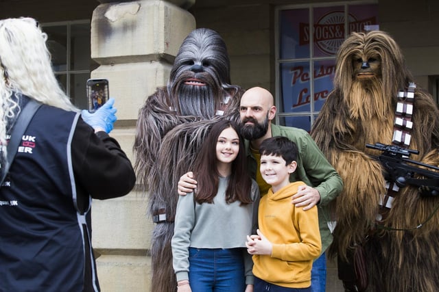 Molly Pugh, 12, Andrew Pugh and Henry Pugh, 10, have their picture taken with wookiees