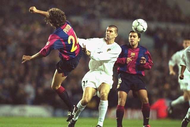 Barcelona's Carlos Puyol clears from Dominic Matteo.