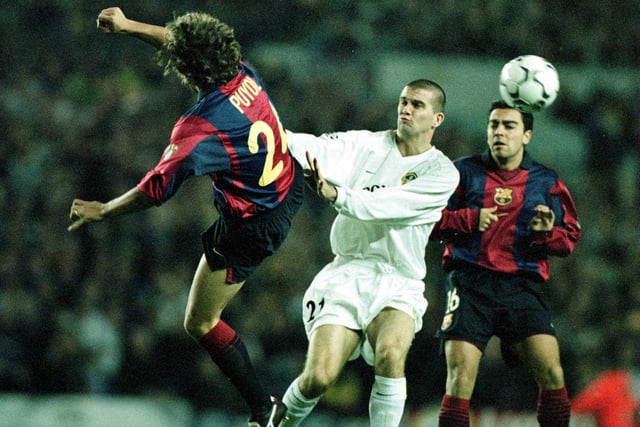 Barcelona's Carlos Puyol and Dominic Matteo challenge for the ball.