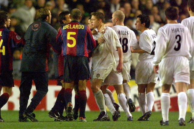 Striker Alan Smith (centre) and his teammates square up to Barcelona's Fernandez Abelardo (second left) and Carles Puyol (left) after the final whistle.