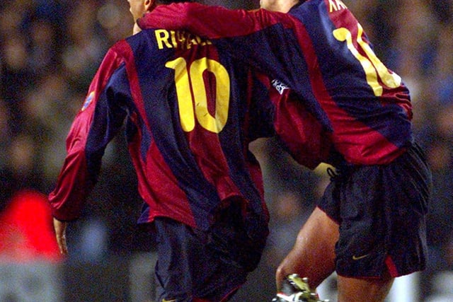 Xavi celebrates with goalscorer Rivaldo after the World Player of the Year scored deep into injury time to deny Leeds United victory.
