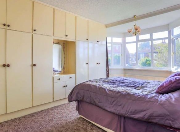 The second bedroom also benefits from fitted wardrobes and a large bay window.