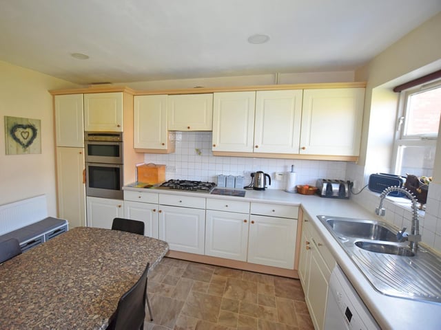 The kitchen diner has a range of base and wall fitted units.