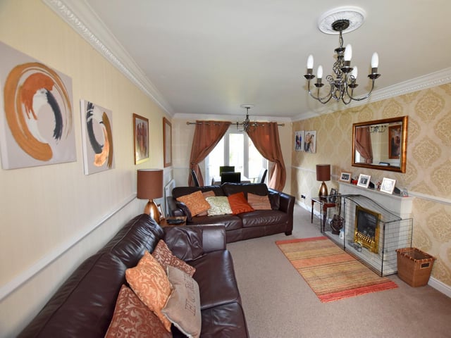 The house lounge has a central fireplace feature.