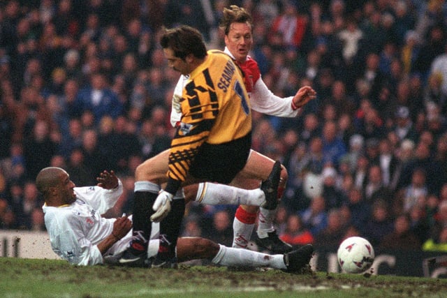 Brian Deane slides the ball past Arsenal's David Seaman watched by Lee Dixon only for the goal to be disallowed during the Premiership clash at Elland Road in February 1997. The game finished 0-0.