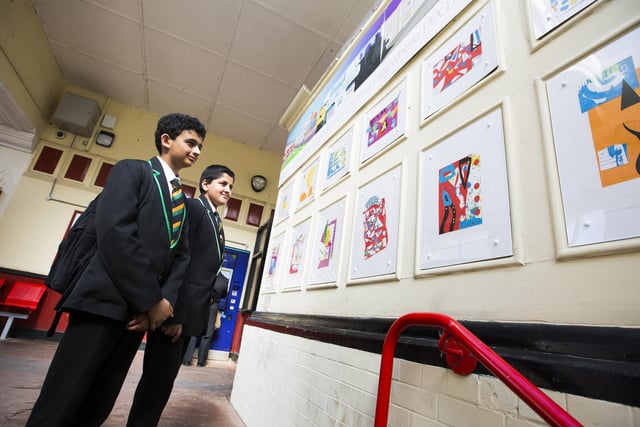 Abubaker Garda, 13, left, and Talhah Afzal, 13, with artworks make by them and other students from Upper Batley High School