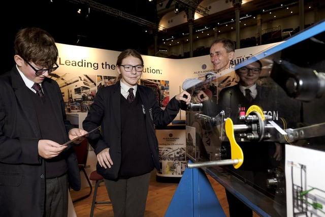 Graham School pupils Lewis and Shelly and Plaxton's representative viewing machinery on the stand.