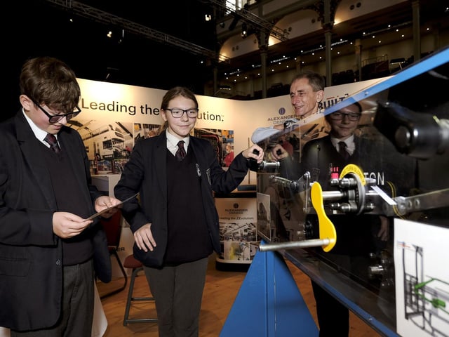 Graham School pupils Lewis and Shelly and Plaxton's representative viewing machinery on the stand.