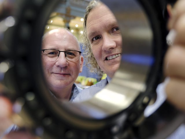 McCain's Chris Cooke with Graham School Teacher Tim Hutchinson viewing a piece of machinery on the stand.