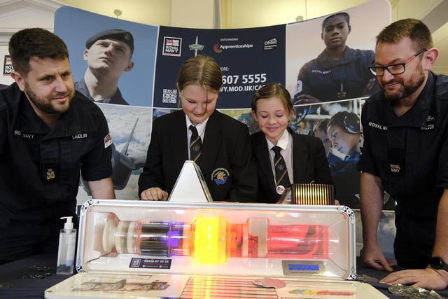 On the RAF stand looking at a generator Staff Dave Laidlaw and Dave Wilson with Caedmon pupils Charlotte and Lexi