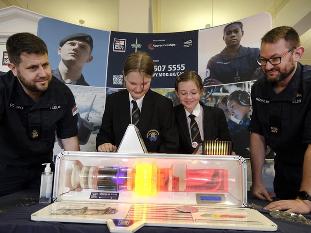 On the RAF stand looking at a generator Staff Dave Laidlaw and Dave Wilson with Caedmon pupils Charlotte and Lexi