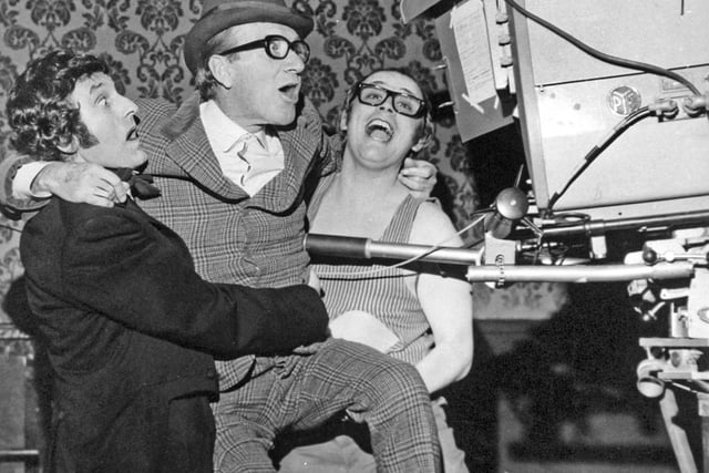 Lonnie Donegan (left) and Kenny Cantor give a lift to Arthur Askey to see through one of the cameras during a break in rehearsals at Leeds City Varieties in January 1971.