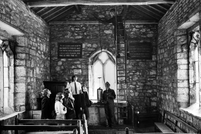 Dry rot experts completed the treatment of the pews and the beams in the historic little church at Lead, near Tadcaster in June 1971. Pictured are Sherburn High School pupils, who keep the church tidy, watch Maurice Kay and Peter Andrew at work