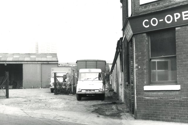 The bottom of Copley Hill onto Back Wellington Row at Wortley in September 1971. A large warehouse is visible to the left with two delivery vehicles belonging to Simon's Fruit, parked in the road.